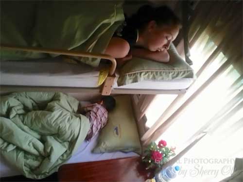Evie sleeps in our train’s sleeper cabin. A young boy and father slept beneath her.
